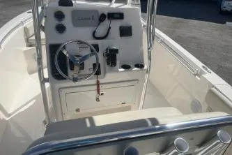 Slide: The Image of 2022 Cobia 237 Center Console boat interior with steering wheel and control panel. - 7