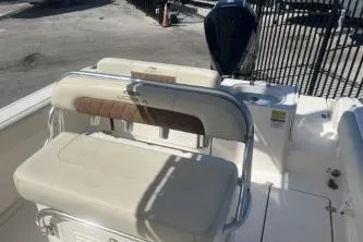 Slide: The Image of 2022 Cobia 237 Center Console boat interior with seating and engine view. - 8
