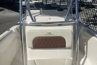 Slide: The Image of 2022 Cobia 237 Center Console boat interior with cushioned seating and metal frame. - 9