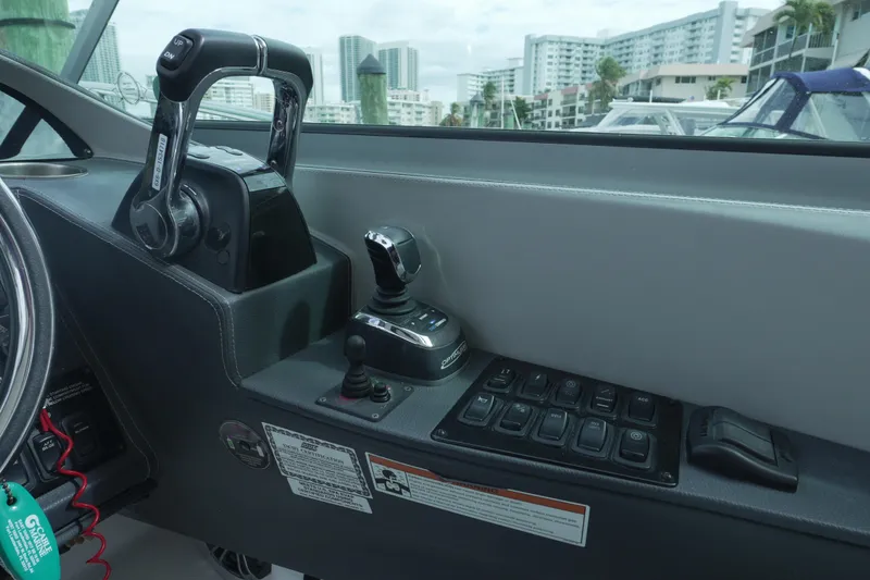 Slide: The Image of Control panel of 2021 Regal 33 XO boat with throttle and joystick. - 10