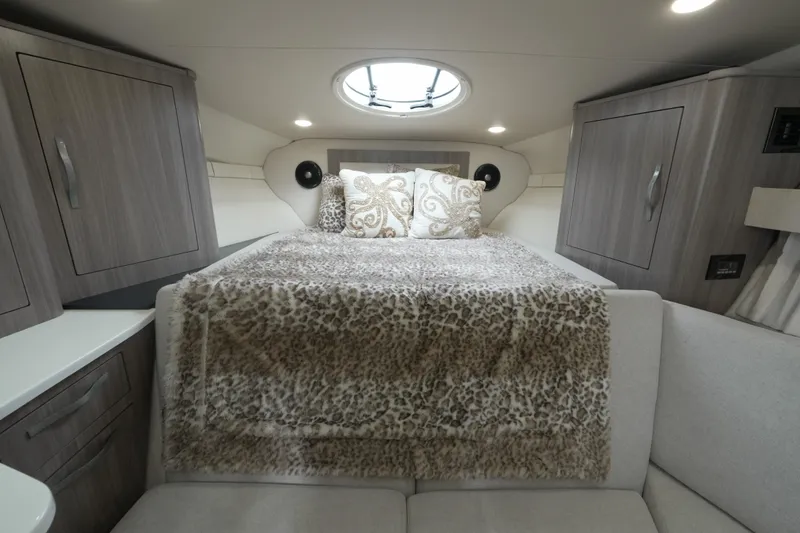 Slide: The Image of Luxurious cabin interior of 2021 Regal 33 XO yacht with plush bedding and modern cabinetry. - 14