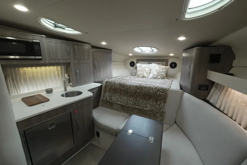 Slide: The Image of Luxurious interior of 2021 Regal 33 XO yacht with kitchenette and cozy sleeping area. - 15