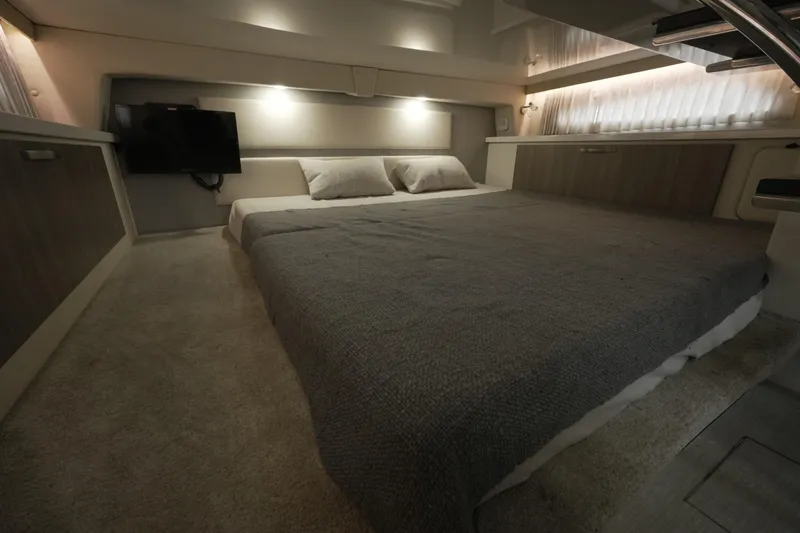 Slide: The Image of Luxurious interior cabin of 2021 Regal 33 XO yacht with cozy bedding and ambient lighting. - 17