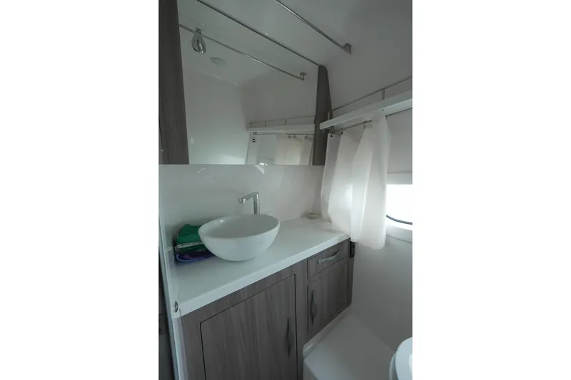 Slide: The Image of 2021 Regal 33 XO boat bathroom with modern sink and cabinetry. - 18