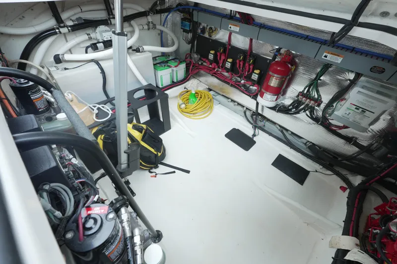 Slide: The Image of Engine room of a 2021 Regal 33 XO boat, featuring wiring and equipment. - 21