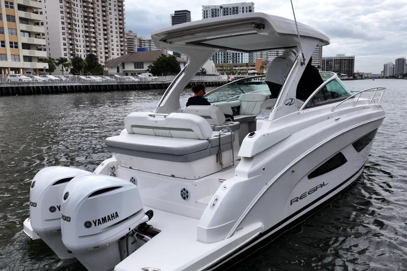 Slide: The Image of 2021 Regal 33 XO boat with Yamaha engines on urban waterway. - 4