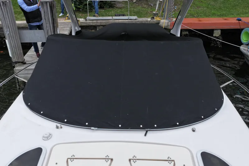 Slide: The Image of 2021 Regal 33 XO boat with black cover docked at marina. - 5