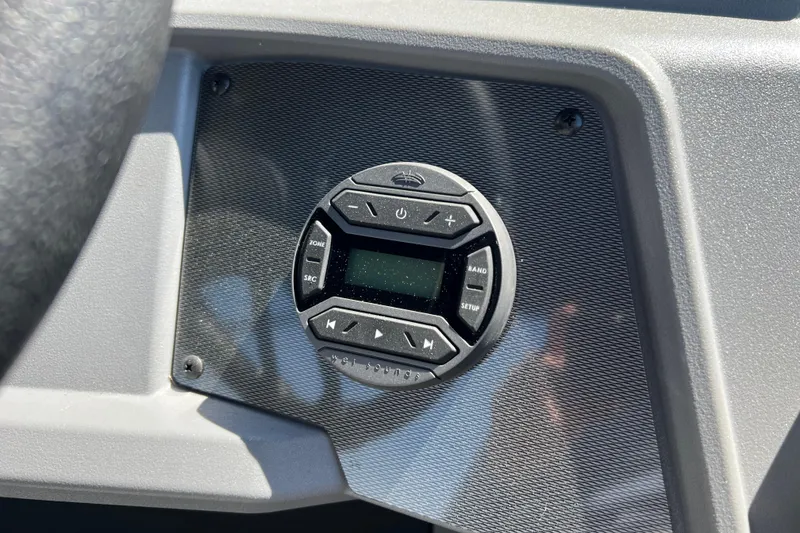 Slide: The Image of Control panel of 2026 Starcraft VX 22 R DH boat, featuring a digital display and buttons. - 16