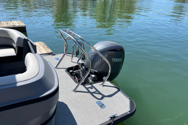 Slide: The Image of 2026 Starcraft VX 22 R DH pontoon boat with Yamaha motor on a calm lake. - 4