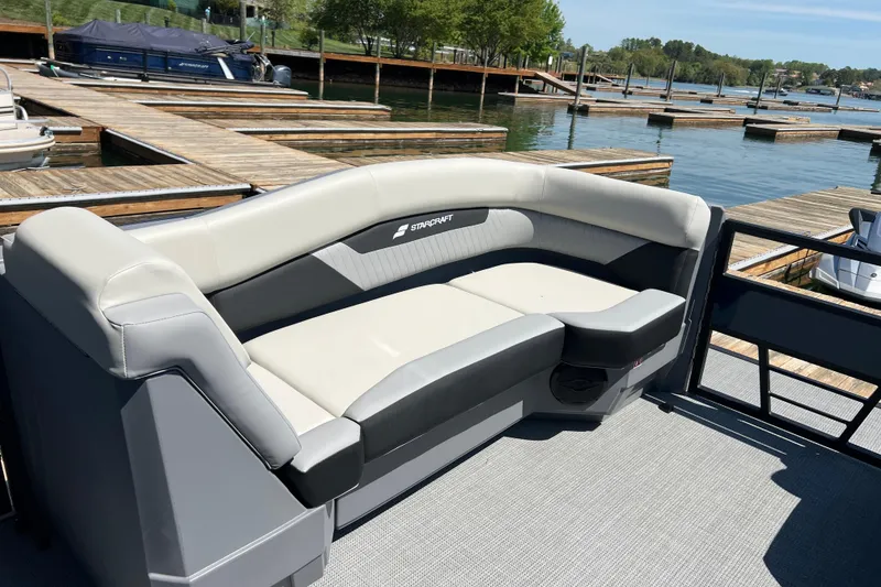 Slide: The Image of 2026 Starcraft VX 22 R DH pontoon boat with sleek seating at a marina dock. - 6