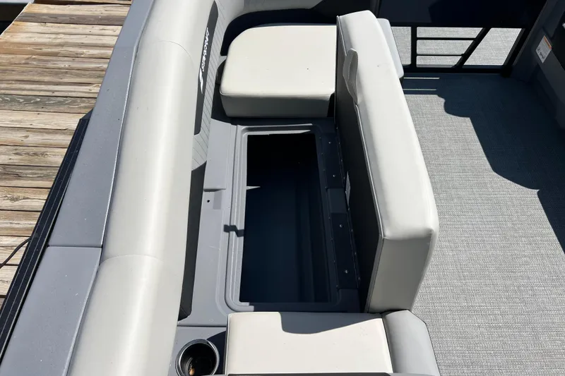 Slide: The Image of 2026 Starcraft VX 22 R DH boat interior with open storage compartment and cushioned seating. - 7