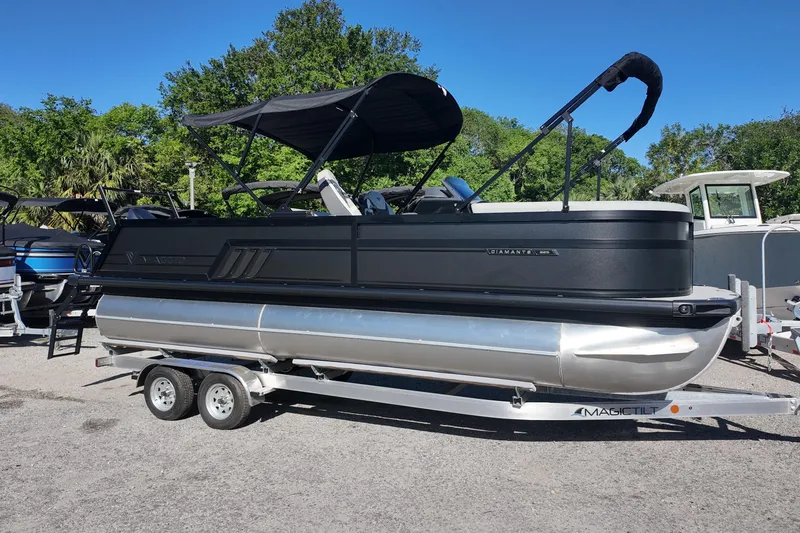 The Image of 2026 Viaggio Diamante S 22 pontoon boat on trailer, parked outdoors. - 0