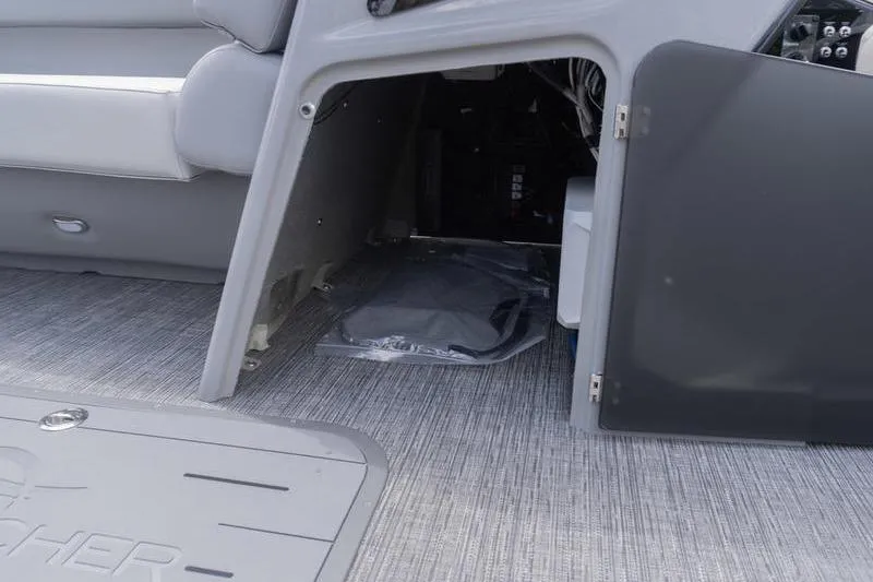 Slide: The Image of 2026 SunCatcher Elite 326 SL boat interior storage compartment with open door. - 12