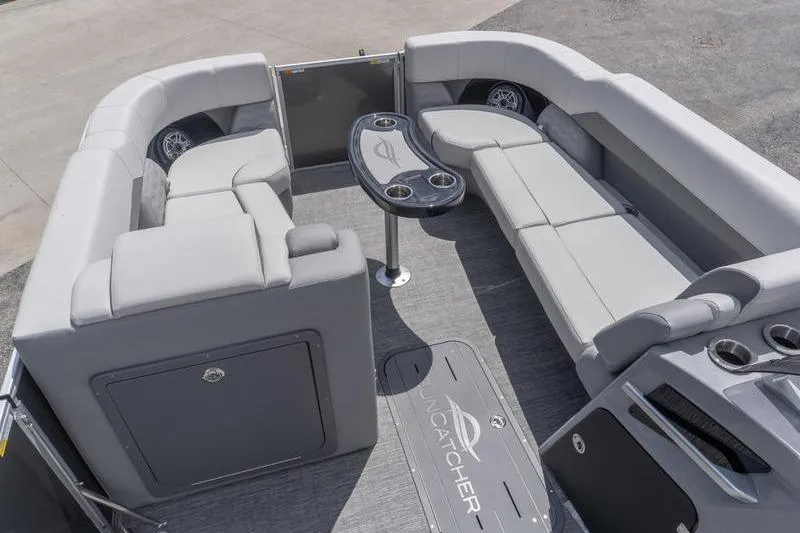 Slide: The Image of Luxurious interior of 2026 SunCatcher Elite 326 SL pontoon boat with plush seating and table. - 13