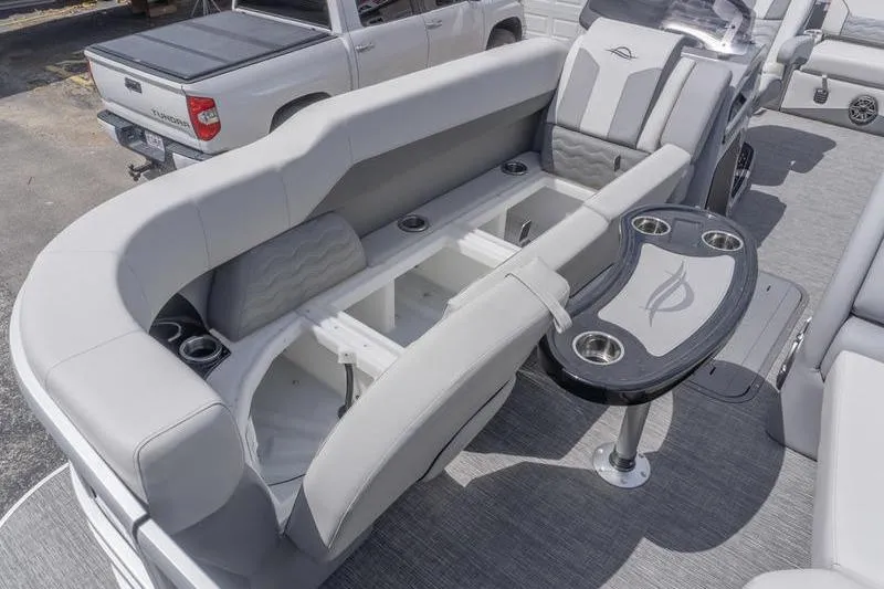 Slide: The Image of 2026 SunCatcher Elite 326 SL boat interior with plush seating and built-in storage compartments. - 17