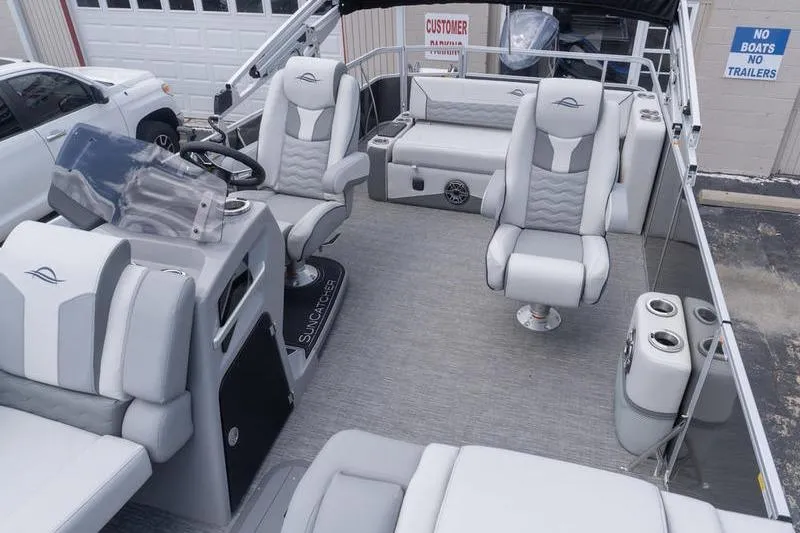 Slide: The Image of 2026 SunCatcher Elite 326 SL pontoon boat interior with luxurious seating and modern design. - 18