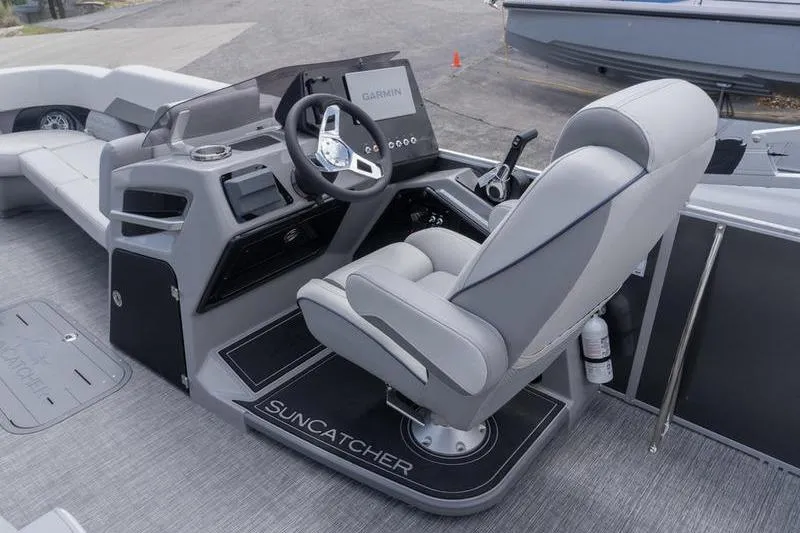 Slide: The Image of 2026 SunCatcher Elite 326 SL boat cockpit with Garmin navigation system and luxurious seating. - 9