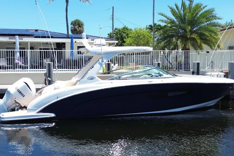 The Image of 2019 Regal 33 OBX boat docked, featuring sleek design and Yamaha outboard engine. - 0