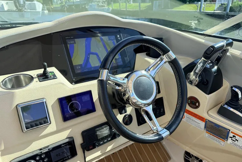 Slide: The Image of Cockpit of 2019 Regal 33 OBX boat with steering wheel and navigation displays. - 10