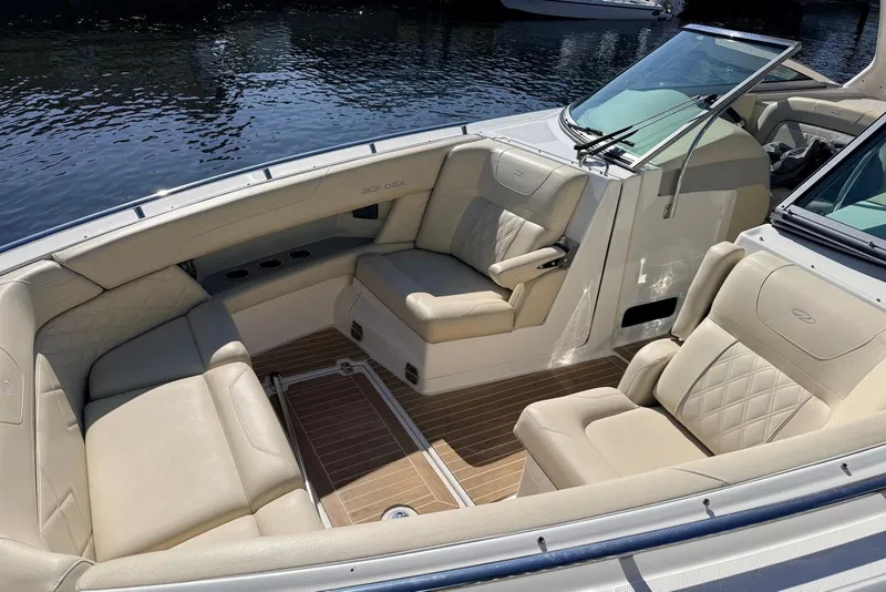 Slide: The Image of Luxurious interior of 2019 Regal 33 OBX boat with beige seating and wood flooring. - 13