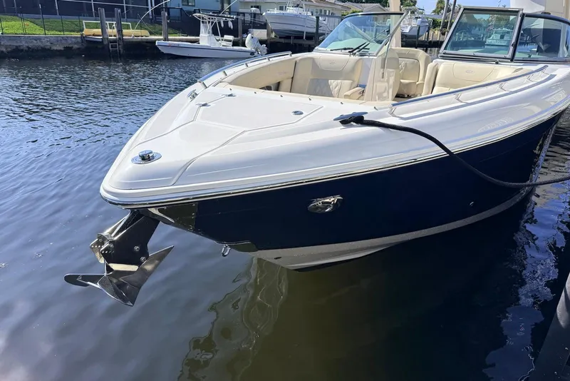 Slide: The Image of 2019 Regal 33 OBX boat docked in calm waters, showcasing sleek design and luxury features. - 3
