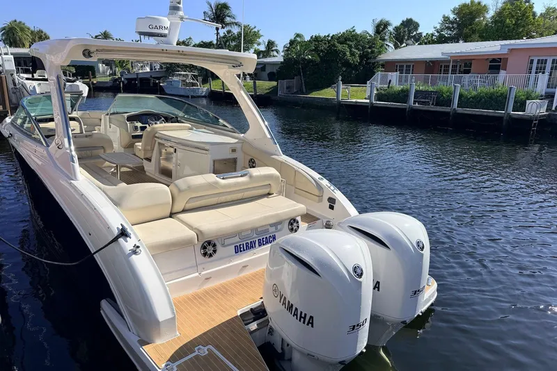 Slide: The Image of 2019 Regal 33 OBX boat with Yamaha engines docked by waterfront homes. - 5