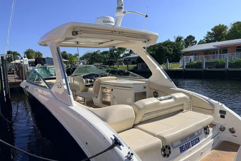Slide: The Image of 2019 Regal 33 OBX boat docked, featuring spacious seating and modern amenities. - 6