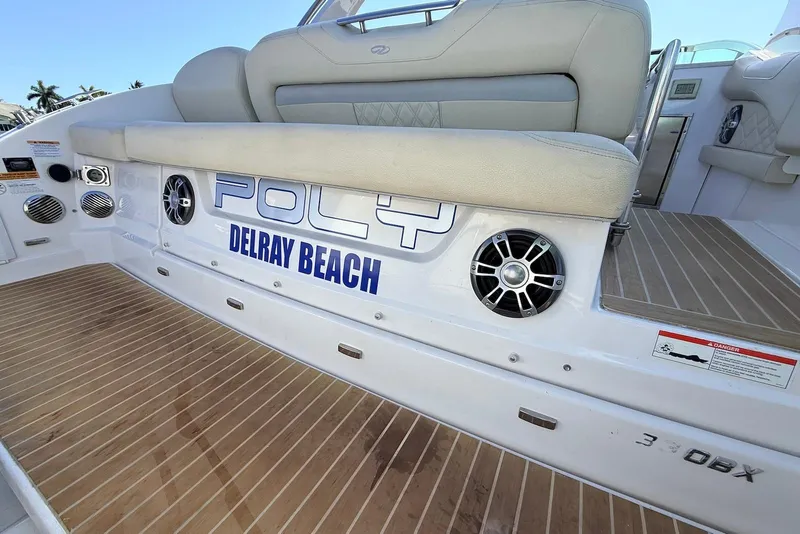 Slide: The Image of 2019 Regal 33 OBX boat interior with speakers and Delray Beach signage. - 7