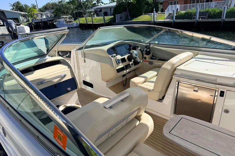 Slide: The Image of 2019 Regal 33 OBX boat interior with beige seating and modern dashboard. - 9