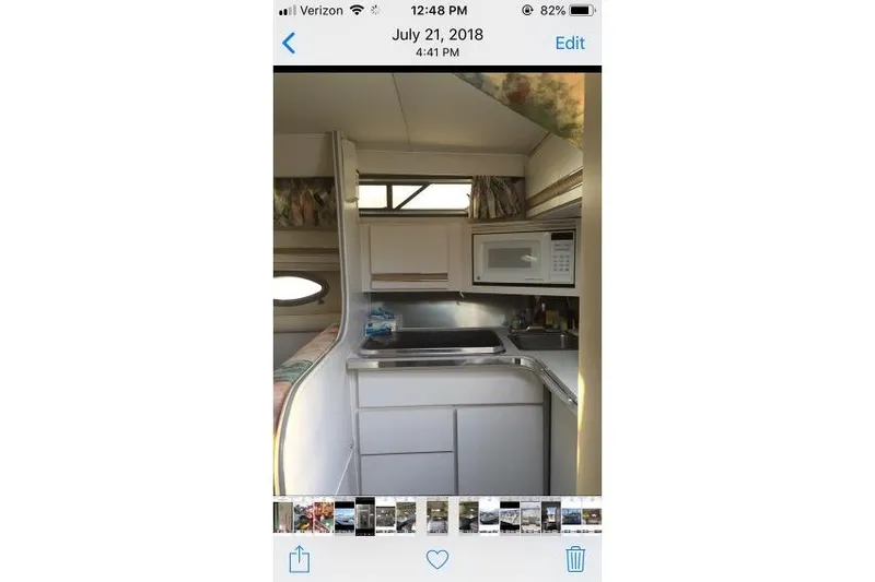 Slide: The Image of Interior of 1989 Wellcraft 3200 St. Tropez boat kitchen with sink and microwave. - 11
