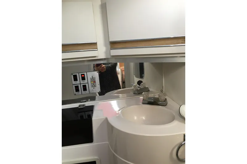 Slide: The Image of Interior of 1989 Wellcraft 3200 St. Tropez boat, featuring a compact bathroom sink. - 15