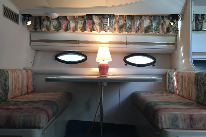 Slide: The Image of Interior of 1989 Wellcraft 3200 St. Tropez boat with cozy dining area and lamp. - 16