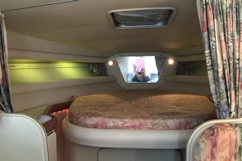 Slide: The Image of Interior cabin of 1989 Wellcraft 3200 St. Tropez with round bed and floral curtains. - 17
