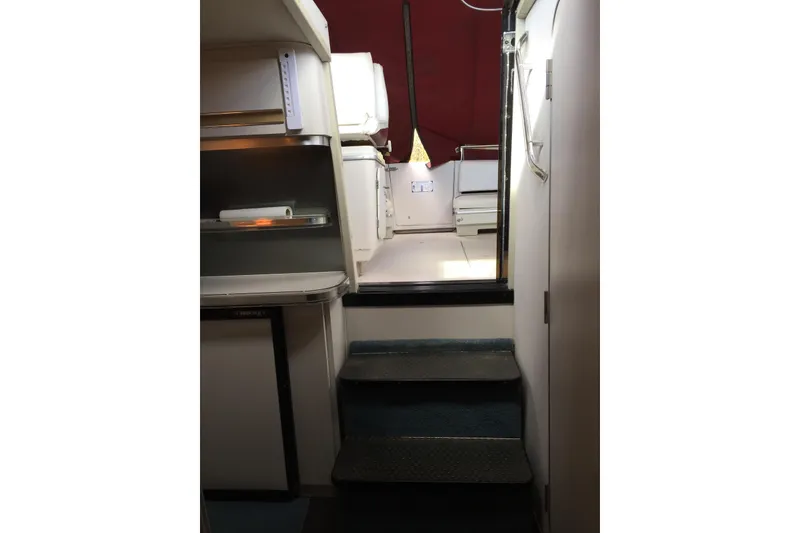 Slide: The Image of Interior view of 1989 Wellcraft 3200 St. Tropez boat cabin with steps and storage. - 7