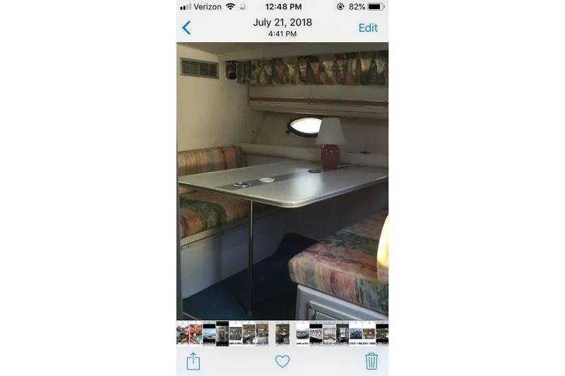 Slide: The Image of 1989 Wellcraft 3200 St. Tropez cabin interior with table and seating area. - 9