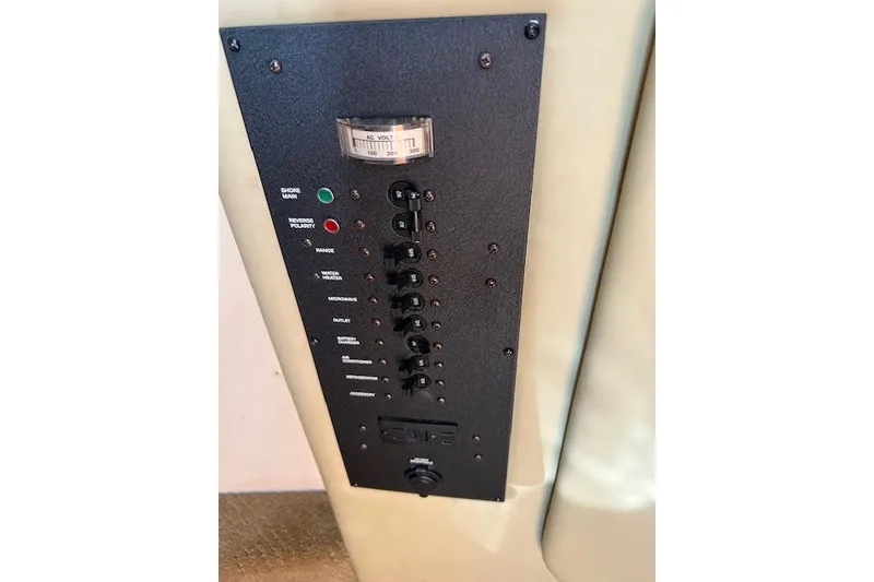 Slide: The Image of Control panel of a 2007 Rinker Fiesta Vee 250 boat with switches and voltmeter. - 10