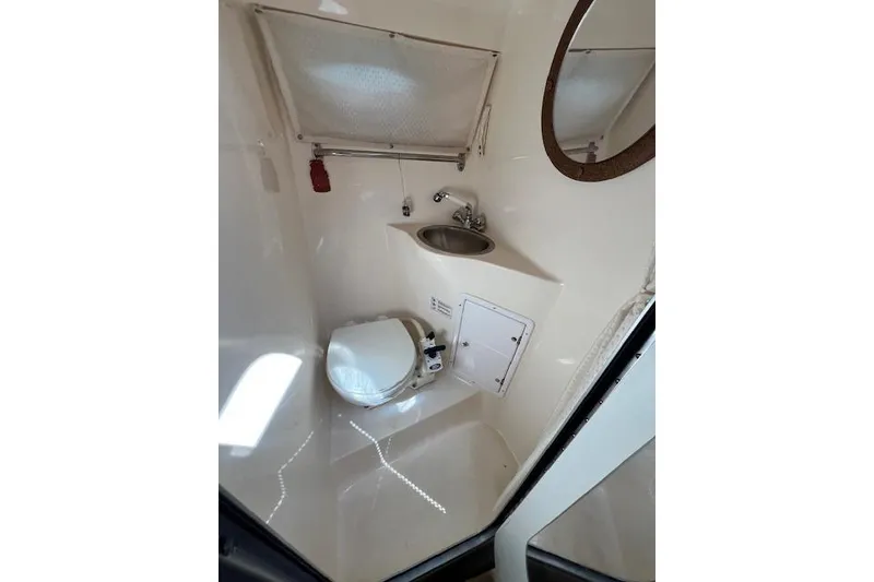 Slide: The Image of 2007 Rinker Fiesta Vee 250 boat bathroom with toilet, sink, and mirror. - 12