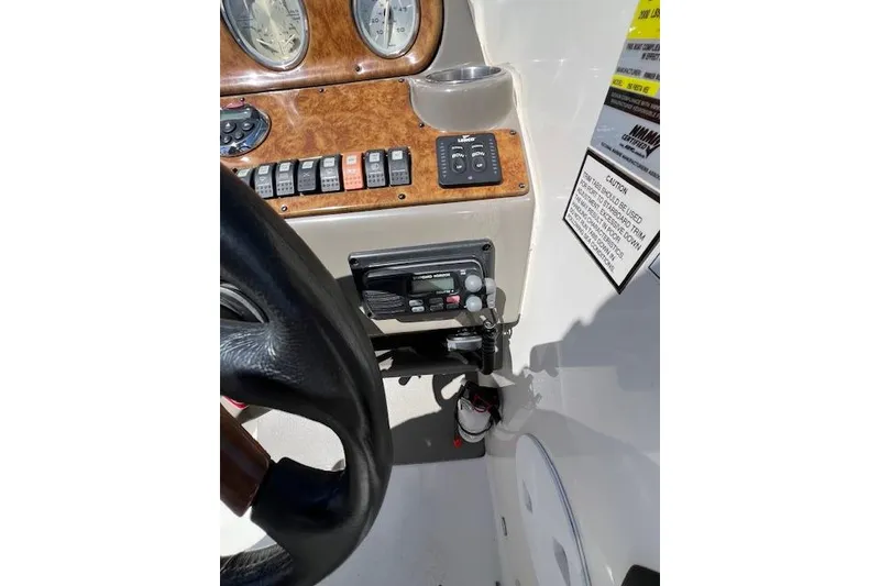 Slide: The Image of 2007 Rinker Fiesta Vee 250 dashboard with gauges, controls, and radio equipment. - 14