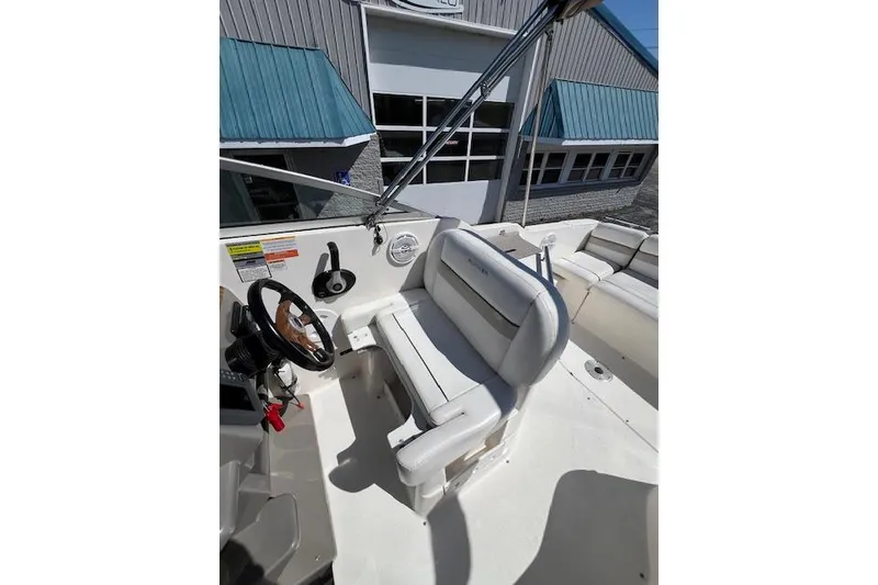 Slide: The Image of 2007 Rinker Fiesta Vee 250 boat interior with steering wheel and seating area. - 16