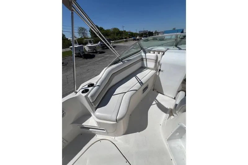 Slide: The Image of 2007 Rinker Fiesta Vee 250 boat interior with white seating and cup holders. - 17