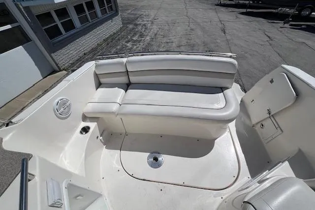 Slide: The Image of 2007 Rinker Fiesta Vee 250 boat interior with white seating and clean deck. - 18