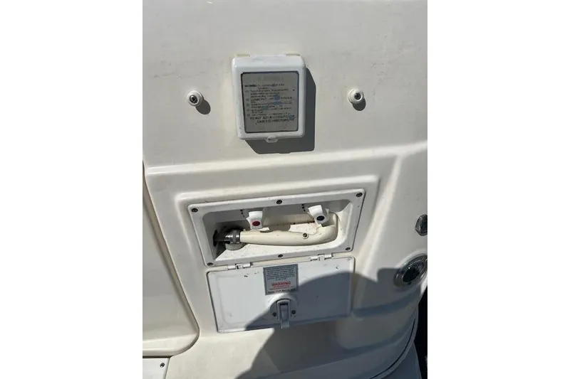 Slide: The Image of 2007 Rinker Fiesta Vee 250 boat exterior with utility access panel. - 20