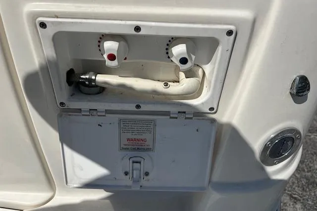 Slide: The Image of 2007 Rinker Fiesta Vee 250 boat shower controls with hot and cold water knobs. - 21