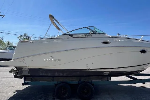 Slide: The Image of 2007 Rinker Fiesta Vee 250 boat on trailer under clear blue sky. - 3