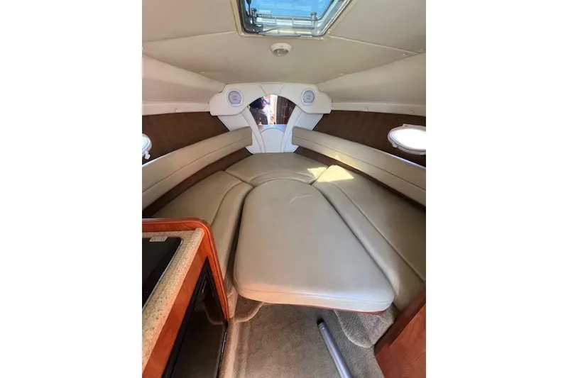Slide: The Image of Interior cabin of 2007 Rinker Fiesta Vee 250 boat with beige seating. - 4