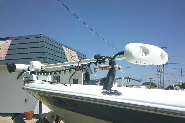Slide: The Image of 2008 NauticStar 2110 Nautic Bay boat with trolling motor, docked under clear blue sky. - 10