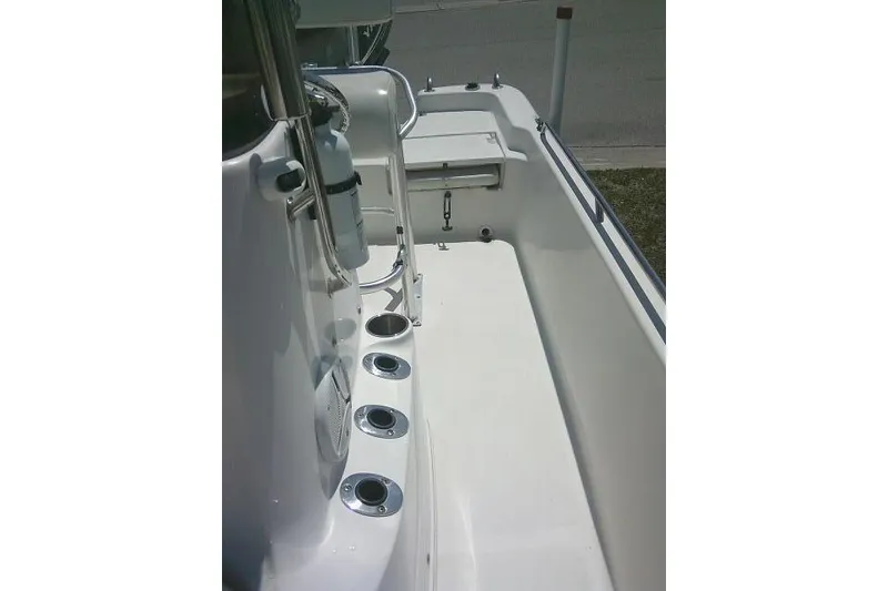 Slide: The Image of 2008 NauticStar 2110 Nautic Bay boat interior with rod holders and storage compartment. - 18