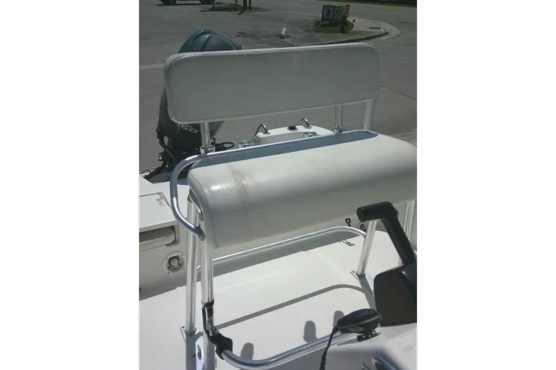 Slide: The Image of 2008 NauticStar 2110 Nautic Bay boat seat and console, featuring white upholstery and metal frame. - 20