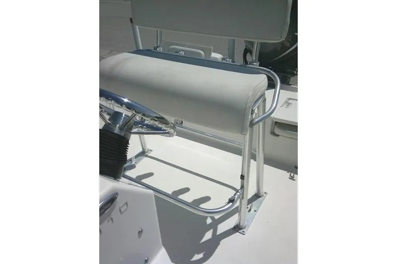 Slide: The Image of 2008 NauticStar 2110 Nautic Bay boat helm with cushioned seat and steering wheel. - 24