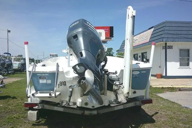 Slide: The Image of 2008 NauticStar 2110 Nautic Bay boat with outboard motor on trailer, parked outdoors. - 5